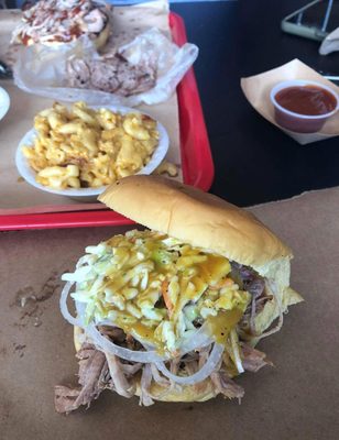 Photo of Smoke BBQ Restaurant & Catering - Fort Lauderdale, FL, US. Pulled Pork sandwich topped with coleslaw, Mac n Cheese