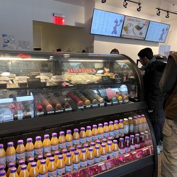 Bing’s Bake & Brew - a man standing in front of a refrigerated display case - Cafes Near Me - Newark, Delaware