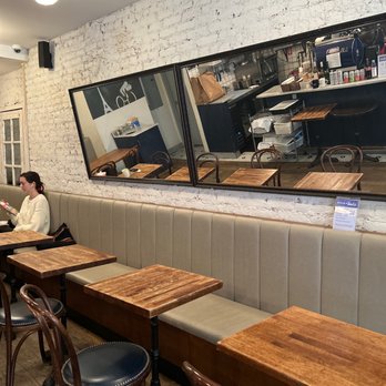 Inès - a woman sitting at a table in a restaurant - Coffee & Tea Near Me - New York, New York