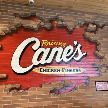 Raising Cane's Chicken Fingers - A photo of  the logo inside the restaurant it's a mural - Chicken Shop Near Me - Canton, Michigan