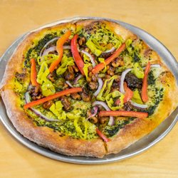 The Wedge Pizzeria - The Barndon comes with pesto, red onion, red bell pepper, pepperoncini, and spiced walnuts