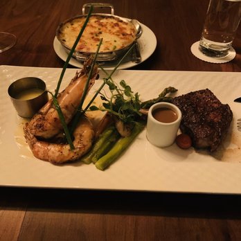 Maison Pucha Bistro - Surf & Turf (New York strip and prawns, added side of au gratin potatoes) - French Near Me - Houston, Texas