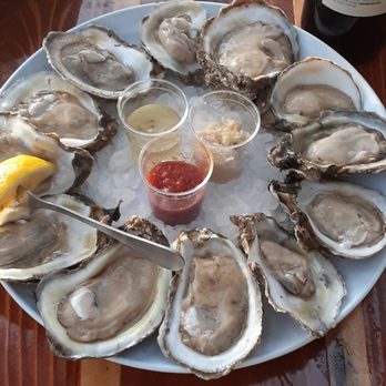 Caps On The Water - A dozen raw oysters with cocktail, horseradish and mignonette sauce - Seafood Near Me - St Augustine, Florida