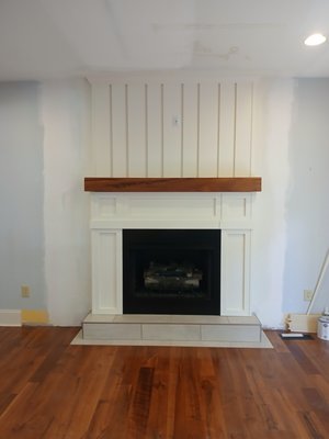Fireplace Renovation - This remodel was tied to an exterior water leak that damaged the existing fireplace and hearth. we removed all the previous finish suround and hearth finished. We resized the firebox opening to accept the new fireplace insert. We installed a new hearth finish, installed a new custom fireplace surround, reinstalled the fireplace insert, and installed a new fireplace mantle with a recessed outlet.