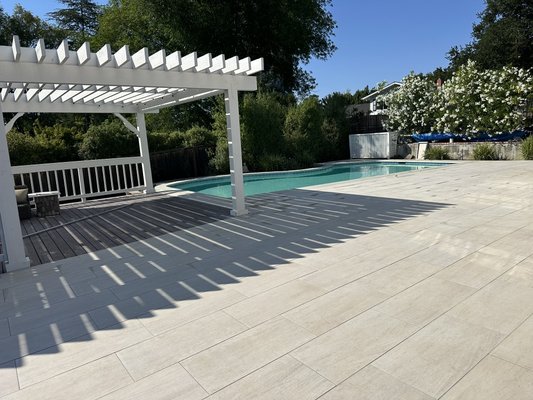 Pool deck construction and landscape design installation. - Pool deck construction and landscaping.