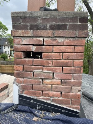 Chimney repair - This customer‘s chimney was crumbling badly and in danger of falling through the roof. In just a single afternoon, we had the corner of the chimney rebuilt, and the rest of it tuck pointed. Now the customer can rest easy, knowing their chimney is secure.