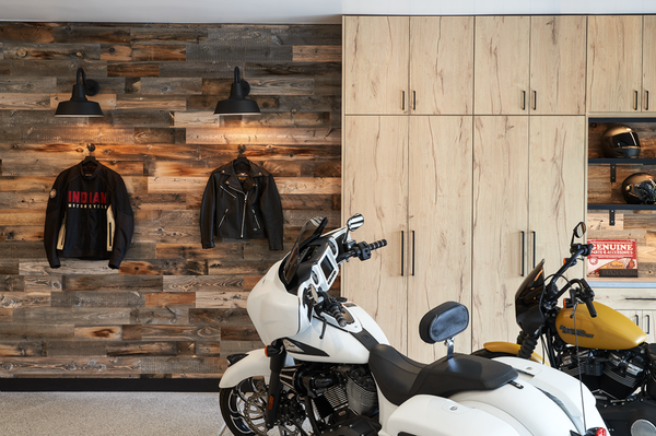 Saddleback Drive - Project scope: Organized the entire home interior. Designed the garage and managed the remodel. Organized the garage after the remodel.
After a whole-house remodel, our clients called on us to organize them back into their cool, modern, industrial home in Danville, CA. The garage was the one part of the home untouched.
Situation: Because the home is set into a hill, the garage is the introduction to the home for anyone pulling up the driveway. Simple white cabinets would not do. What’s more, the family needed the garage to fit two cars, two Harley motorcycles, and a golf cart.
Solution: The garage needed to set the stage for the modern aesthetic inside. Two fixed elements drove the design: a crawl space door that couldn’t be enlarged or moved and an HVAC room. We managed our partner vendors for demolition and hauling, construction, flooring, cabinets, paint, four different wall finishes, electrical and lighting features. The new garage fit everything they needed and used regularly, in addition to all of their vehicles.
Design details: a custom peg board that swings open to access the crawl space, Italian laminate cabinetry with a custom toe kick, a floating shoe shelf installed into the sand-molded brick wall with overhead barn lights to illuminate the featured art, epoxy floor, sensored overhead lighting, barn lights and under-cabinet lighting, black matte hardware, pullout shelves, a Stikwood feature wall with adjacent cabinets to store and showcase the couple’s motorcycle gear.
This project was photographed by Thomas Kuoh. Saddleback Drive - Project scope: Organized the entire home interior. Designed the garage and managed the remodel. Organized the garage after the remodel.
After a whole-house remodel, our clients called on us to organize them back into their cool, modern, industrial home in Danville, CA. The garage was the one part of the home untouched.
Situation: Because the home is set into a hill, the garage is the introduction to the home for anyone pulling up the driveway. Simple white cabinets would not do. What’s more, the family needed the garage to fit two cars, two Harley motorcycles, and a golf cart.
Solution: The garage needed to set the stage for the modern aesthetic inside. Two fixed elements drove the design: a crawl space door that couldn’t be enlarged or moved and an HVAC room. We managed our partner vendors for demolition and hauling, construction, flooring, cabinets, paint, four different wall finishes, electrical and lighting features. The new garage fit everything they needed and used regularly, in addition to all of their vehicles.
Design details: a custom peg board that swings open to access the crawl space, Italian laminate cabinetry with a custom toe kick, a floating shoe shelf installed into the sand-molded brick wall with overhead barn lights to illuminate the featured art, epoxy floor, sensored overhead lighting, barn lights and under-cabinet lighting, black matte hardware, pullout shelves, a Stikwood feature wall with adjacent cabinets to store and showcase the couple’s motorcycle gear.
This project was photographed by Thomas Kuoh.