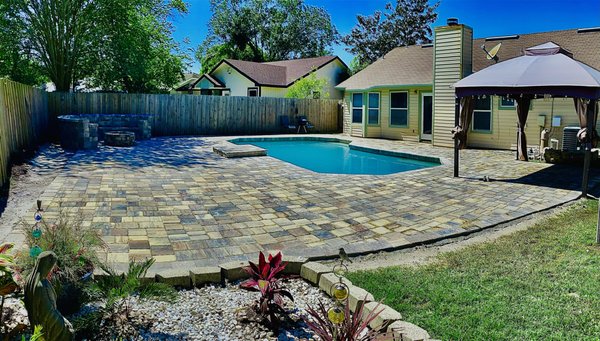 Pool Deck Renovation - Angela had an old pool deck that needed a facelift. There were cracks and stains everywhere, so she called the Paver Kings to see what we can do. We completely remodeled her deck with brand new pavers and even expanded her deck by another 1,000 sq-ft! We added a firepit seating area and some palm trees. Now Angela is chilling in her backyard paradise. Pool Deck Renovation - Angela had an old pool deck that needed a facelift. There were cracks and stains everywhere, so she called the Paver Kings to see what we can do. We completely remodeled her deck with brand new pavers and even expanded her deck by another 1,000 sq-ft! We added a firepit seating area and some palm trees. Now Angela is chilling in her backyard paradise.