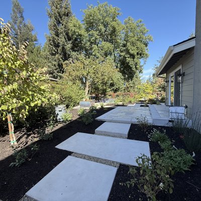 Backyard Renovation with New Concrete and Fire Pit - Backyard Renovation from Demolition to creating an outdoor space with Concrete Patios and Paths, Fire Pit with Porcelain Tile, New Lawn surrounded by Planters Beds covered in Mulch. Backyard Renovation with New Concrete and Fire Pit - Backyard Renovation from Demolition to creating an outdoor space with Concrete Patios and Paths, Fire Pit with Porcelain Tile, New Lawn surrounded by Planters Beds covered in Mulch.