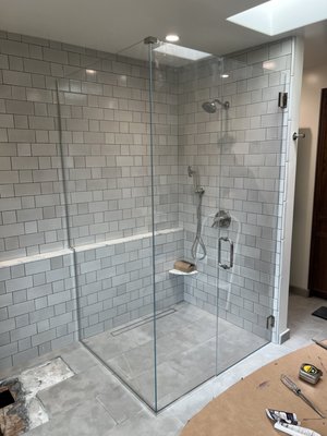 Custom Frameless Shower Glass Gallery - This gallery highlights a selection of some of our custom frameless shower glass installations, showcasing a variety of designs, layouts, and finishes tailored to each client's space. Every enclosure is custom measured and fabricated to ensure a precise fit, clean lines, and a seamless appearance. These projects demonstrate the versatility and elegance of frameless glass, from spacious walk-in showers to more intricate custom configurations. Our goal is to create beautiful, functional shower enclosures that enhance the overall look and feel of the bathroom while providing lasting durability. Each installation reflects our commitment to quality craftsmanship, attention to detail, and professional installation. We take pride in helping homeowners bring their vision to life with custom glass solutions designed specifically for their homes. Custom Frameless Shower Glass Gallery - This gallery highlights a selection of some of our custom frameless shower glass installations, showcasing a variety of designs, layouts, and finishes tailored to each client's space. Every enclosure is custom measured and fabricated to ensure a precise fit, clean lines, and a seamless appearance. These projects demonstrate the versatility and elegance of frameless glass, from spacious walk-in showers to more intricate custom configurations. Our goal is to create beautiful, functional shower enclosures that enhance the overall look and feel of the bathroom while providing lasting durability. Each installation reflects our commitment to quality craftsmanship, attention to detail, and professional installation. We take pride in helping homeowners bring their vision to life with custom glass solutions designed specifically for their homes.