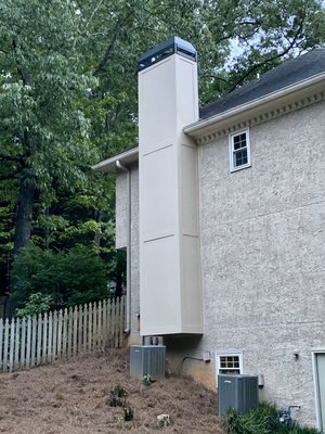Badly damaged stucco chimney rebuild. - Customer had us out to evaluate a water leak. We found that the utility flue was missing a storm collar and the rain pan didn’t fit the chimney. It covered the framing but not the stucco. The stucco was installed over the bottom of the pan. This chimney had leaked since day one, for approximately 30 years.
This is obviously a worst case scenario, but the issue with the pan being installed before the stucco is more common than we’d prefer to see. With this job we weren’t expecting the framing to be this bad. Typically, replacing the siding is sufficient. We do hard coat stucco, cement board, stacked stone and brick chimneys. The customer chose to reduce the overall height, for aesthetics and financial reasons, and to switch to cement board HardiePanels for the ease of maintenance and to prevent future leaks.
We replaced the flashing and installed lockouts, installed all new framing, OSB subsurface and heavy felt paper moisture barrier, new insulation where it was lacking, and cement board panels and trim. We then caulked the seams with paintable caulk and painted the chimney.
With that complete we installed a new custom black powder coated rain pan with cross bracing and a 1/2” drip edge. We ensured that the turn down and drip edge of the pan properly covered the trim to prevent leaks. The cross bracing helps keep water from pooling, which leads to rusting, and the drip edge keeps water from running down the sides of the chimney, which leads to staining. At customer request we also fabricated and installed a custom decorative wind shroud to obscure the termination caps and provide a higher end, more finished look.
We then removed the scaffolding and roof covering, cleaned up the work area and ran a magnet over the yard to remove nails and screws. Prior to setting up the scaffolding we also removed an overgrown bush (at customer request) to provide a safe work environment. Badly damaged stucco chimney rebuild. - Customer had us out to evaluate a water leak. We found that the utility flue was missing a storm collar and the rain pan didn’t fit the chimney. It covered the framing but not the stucco. The stucco was installed over the bottom of the pan. This chimney had leaked since day one, for approximately 30 years.
This is obviously a worst case scenario, but the issue with the pan being installed before the stucco is more common than we’d prefer to see. With this job we weren’t expecting the framing to be this bad. Typically, replacing the siding is sufficient. We do hard coat stucco, cement board, stacked stone and brick chimneys. The customer chose to reduce the overall height, for aesthetics and financial reasons, and to switch to cement board HardiePanels for the ease of maintenance and to prevent future leaks.
We replaced the flashing and installed lockouts, installed all new framing, OSB subsurface and heavy felt paper moisture barrier, new insulation where it was lacking, and cement board panels and trim. We then caulked the seams with paintable caulk and painted the chimney.
With that complete we installed a new custom black powder coated rain pan with cross bracing and a 1/2” drip edge. We ensured that the turn down and drip edge of the pan properly covered the trim to prevent leaks. The cross bracing helps keep water from pooling, which leads to rusting, and the drip edge keeps water from running down the sides of the chimney, which leads to staining. At customer request we also fabricated and installed a custom decorative wind shroud to obscure the termination caps and provide a higher end, more finished look.
We then removed the scaffolding and roof covering, cleaned up the work area and ran a magnet over the yard to remove nails and screws. Prior to setting up the scaffolding we also removed an overgrown bush (at customer request) to provide a safe work environment.