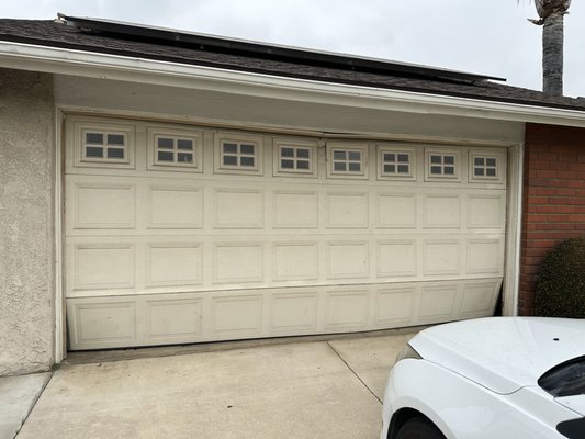 Wood-Grain Garage Door Replacement – Newport Beach, CA - This garage door replacement was completed for a homeowner in Newport Beach, CA, who wanted to upgrade from a damaged and outdated door to something more elegant and secure. The original beige door had dents and alignment issues, affecting both appearance and functionality. Our team at Rollit Garage Doors installed a new insulated steel door with a realistic wood-grain finish and modern geometric windows. The result completely transformed the home’s exterior — adding warmth, curb appeal, and smoother, quieter performance. As always, this installation was completed in one day and backed by our warranty.