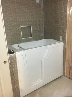 Bathroom remodeling - Remodeled basement with a walk in tub and custom tile with niche and surround. Bathroom remodeling - Remodeled basement with a walk in tub and custom tile with niche and surround.