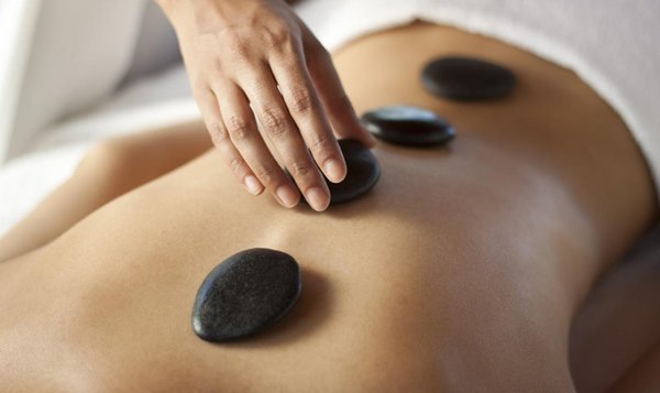 Relax with a hot stone message! - Heat is a well-known natural pain reliever. If tension is behind an ache or pain, then heat can be enormously effective at releasing the tension and thus easing the pain. This is believed to be because when heat is applied to an area, the blood flow to that region increases. It can help alleviate spasms and enable a joint or muscles to be gently flexed and regain movement and mobility. BOOK YOUR HOT STONE MASSAGE TODAY!