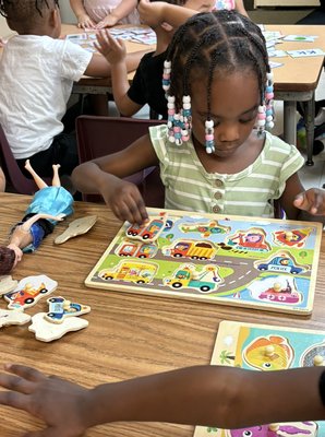 Puzzle play - Toddlers at circle time Puzzle play - Toddlers at circle time