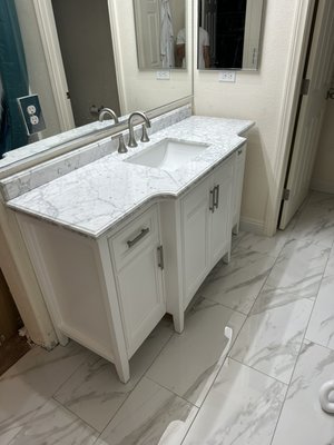 Vanity Upgrade - This is a few progress pictures of a vanity replacement. Due to the nature of the new vanity and visibility under it, we had to redo the tile. This project included flooring, drywall repair and texture, basic plumbing for new location of the sink and caulking.