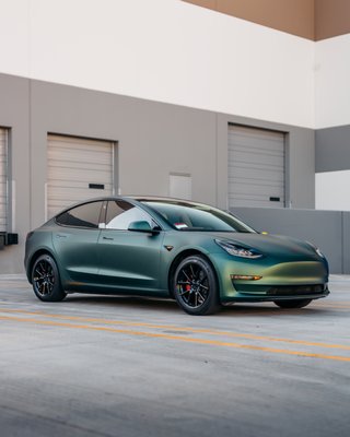 Matte Pine Green Metallic Tesla Model 3 - We completed a 3M Matte Pine Green Metallic wrap on the Tesla Model 3. Additionally, we painted the calipers a custom copper/rising sun color and matched the accents. Matte Pine Green Metallic Tesla Model 3 - We completed a 3M Matte Pine Green Metallic wrap on the Tesla Model 3. Additionally, we painted the calipers a custom copper/rising sun color and matched the accents.