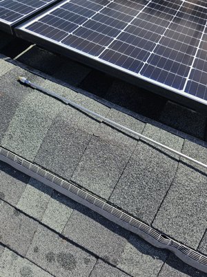 Treatment with solar panels - We treated these shingles with solar panels using our probe. These shingles were "50 year shingles" that appeared to have reached the end of their life in several areas at less than 20 years. We treated to add significant life span to the roof and avoid the expense of having to remove the solar panels and replace them in order to replace the shingles. We also treated the shed which was already showing significant granule loss.