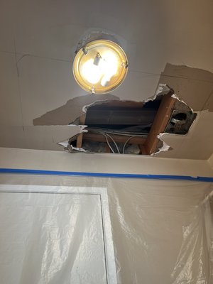 Ceiling reparation - We repaired the ceiling of a laundry room, installed drywall panels, and applied plaster and texture.