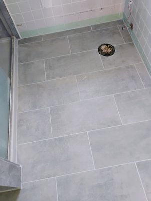 Bathroom Floor 1'x2' grey tiles brick pattern - This new floor was put in for a customer that had found some tiles that they loved. We just used the 1/4" hardibacker cement board as an underlayment to keep it as close as possible with the wood floor in the hallway. We like to give as many options as possible for the completed look so you always get a result you love. Bathroom Floor 1'x2' grey tiles brick pattern - This new floor was put in for a customer that had found some tiles that they loved. We just used the 1/4" hardibacker cement board as an underlayment to keep it as close as possible with the wood floor in the hallway. We like to give as many options as possible for the completed look so you always get a result you love.
