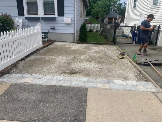 Parking Pad with granite apron - Is there a secret to perfectly flat asphalt? Yes. And it's been handed down---father to son--for three generations. It may matter to us more than you. We have a legacy to maintain. We do the worrying for you.