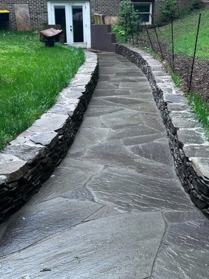 Backyard Walkway and Circular Patio with Retaining Walls - In this project, we transformed an empty yard by creating a beautiful, functional walkway that leads to a circular patio. To enhance the space and prevent debris from getting into the walkway and patio, we added retaining walls, making the backyard both inviting and usable. The result is a well-structured outdoor area, perfect for relaxation and gatherings. Backyard Walkway and Circular Patio with Retaining Walls - In this project, we transformed an empty yard by creating a beautiful, functional walkway that leads to a circular patio. To enhance the space and prevent debris from getting into the walkway and patio, we added retaining walls, making the backyard both inviting and usable. The result is a well-structured outdoor area, perfect for relaxation and gatherings.