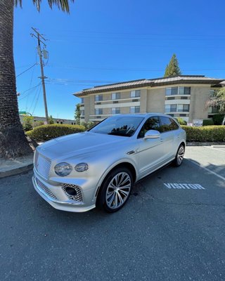 Bentley Bentayga - This project started as a simple enhancement and ended up as a total transformation. We wrapped the entire vehicle is 3M satin silver white aluminum and added a complete factory Bentley Speed aero kit Bentley Bentayga - This project started as a simple enhancement and ended up as a total transformation. We wrapped the entire vehicle is 3M satin silver white aluminum and added a complete factory Bentley Speed aero kit