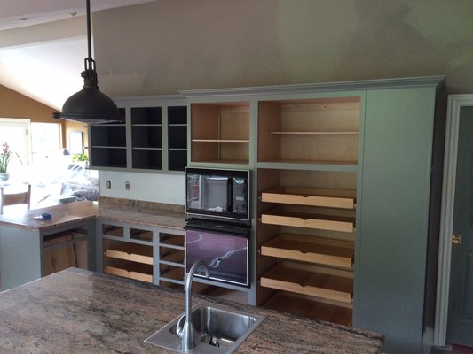 Kitchen Cabinet rehab from natural maple finish to pigmented urethane finish. Includes industrial shelving installation. - This kitchen had a great solid cabinet system installed from original build. The existing finish was a clear solid maple. The client wanted a change with an industrial look. The existing foot print was good and no changes were needed with exception of removing cabinet doors and adding glass doors for a elegant looking China storage cabinet and painting interiors for that industrial look the client was looking for. The new shelving added to the industrial look as well with the galvanized pipe as shed brackets. The fins paint product used was an acrylic urethane enamel which adds a very durable color lasting finish. Kitchen Cabinet rehab from natural maple finish to pigmented urethane finish. Includes industrial shelving installation. - This kitchen had a great solid cabinet system installed from original build. The existing finish was a clear solid maple. The client wanted a change with an industrial look. The existing foot print was good and no changes were needed with exception of removing cabinet doors and adding glass doors for a elegant looking China storage cabinet and painting interiors for that industrial look the client was looking for. The new shelving added to the industrial look as well with the galvanized pipe as shed brackets. The fins paint product used was an acrylic urethane enamel which adds a very durable color lasting finish.