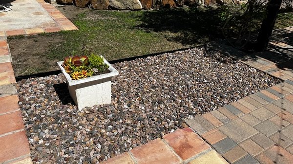 Sod removal for crushed gravel with steel black edging. - Client wanted to remove large portions of dying sod from their yard and replace with 3/4 in crushed gravel, separated with a col met steel black edging.