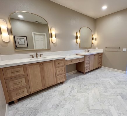 Master bathroom partial remodel - We demoed the carpet, vanity, lighting, mirrors, drywall on the vanity and started new. We installed herringbone marble floor tile, new white oak cabinets, countertops, sinks, faucets, sconces, mirrors, overhead lighting, and hardware. Master bathroom partial remodel - We demoed the carpet, vanity, lighting, mirrors, drywall on the vanity and started new. We installed herringbone marble floor tile, new white oak cabinets, countertops, sinks, faucets, sconces, mirrors, overhead lighting, and hardware.