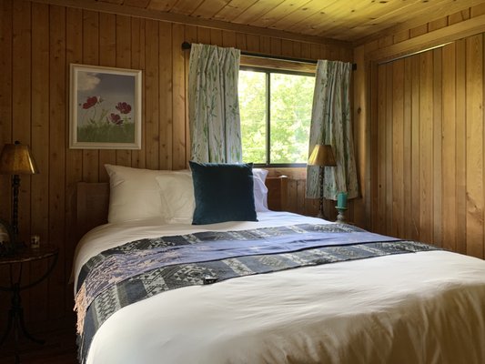 Bluebird Room - The Bluebird Room is located on the second floor in the southwest corner, with two windows overlooking the meadow and surrounding forests. Look over your shoulder at night to see the North Star! Features include:
•	The quiet warmth of pine walls and ceiling, and oak floor 
•	Queen size handcrafted maple bed
•	Fine cotton sheets, comforters, and plush towels 
•	Bedside lamps for nighttime reading
•	Private bath with lavatory, tub and shower
•	Locally made organic soap and shampoo
•	A plush robe for each guest.