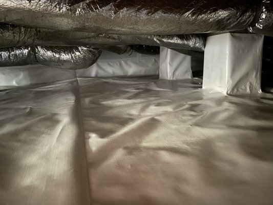 Crawl Space Encapsulation - Mrs. K was experiencing issues with moisture in the crawl spaces and it was causing mold and mildew.  We remediated the mold and installed an encapsulation system.  The waterproofing system included plastic on the floor and walls of the crawl space, a commercial grade dehumidifier, and relative humidity monitor so the humidity level of the crawl space can be monitored from the comfort of the home. Now the crawl space will stay dry, which in-turn will keep the wooden parts of the foundation dry and safe from rot.  Even the air quality in the home will improve, and provide a safe environment for the family to live in.