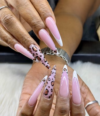 Pink Ombré Leopard Stiletto Nails - Custom stiletto acrylic nail set featuring soft pink ombré, white tips, and hand-painted leopard print accents. This design combines a clean, feminine look with a bold, trendy touch—perfect for clients who want something both elegant and eye-catching.