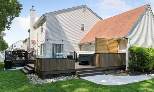 Ground-level Composite Deck w/ Hot Tub & Custom Planter Boxes - A customer connected with our sales team regarding a deck removal and extensive backyard improvement; build a custom deck around an eye-catching water feature with roof coverage and lighting. The homeowner was ready to invest in the next 20+ years at their beloved home to host annual gatherings while watching their grandchildren grow up. Although ready to get started, this anxious couple had no idea of the deck replacement cost and how they would finance a deck build. Fixing the rotted deck had been ruled out once since this old, 1990s-era composite had reached its shelf life.
Understanding the customers vision is key to a successful build & customer experience. We understood right away the major factor to getting this backyard makeover just right was the aesthetic. Luckily, at Dexteriors we have an in-house Deck Design Team using our own custom deck estimating software to create and develop any project. We gathered information about lifestyle, interior design preferences, and other elements that would help give the project characteristics that appealed to the homeowner’s style. The process started off slow while determining whether to utilize a traditional in-ground (gunite) pool, a jet-powered swim spa for in-place lap swimming, or a hot tub.
Considering the wants/needs, yard space and building restrictions, our outdoor experts generated covered deck plans that included a hot tub nestled in a corner. Being in the neighbor’s view, we created a flower planter box with privacy wall to reduce sight lines.
The final design includes a roof covering that you’ll see in our digital deck design renderings. After careful planning, the homeowner and our team customized a two-phase building process to complete the primary deck space in 2024, and complete the roof and outdoor bar installation in ‘25/’26. This will include lighting, ceiling fan, granite bar top & cabinets, and a wall-mounted TV under a shed-style roof. Ground-level Composite Deck w/ Hot Tub & Custom Planter Boxes - A customer connected with our sales team regarding a deck removal and extensive backyard improvement; build a custom deck around an eye-catching water feature with roof coverage and lighting. The homeowner was ready to invest in the next 20+ years at their beloved home to host annual gatherings while watching their grandchildren grow up. Although ready to get started, this anxious couple had no idea of the deck replacement cost and how they would finance a deck build. Fixing the rotted deck had been ruled out once since this old, 1990s-era composite had reached its shelf life.
Understanding the customers vision is key to a successful build & customer experience. We understood right away the major factor to getting this backyard makeover just right was the aesthetic. Luckily, at Dexteriors we have an in-house Deck Design Team using our own custom deck estimating software to create and develop any project. We gathered information about lifestyle, interior design preferences, and other elements that would help give the project characteristics that appealed to the homeowner’s style. The process started off slow while determining whether to utilize a traditional in-ground (gunite) pool, a jet-powered swim spa for in-place lap swimming, or a hot tub.
Considering the wants/needs, yard space and building restrictions, our outdoor experts generated covered deck plans that included a hot tub nestled in a corner. Being in the neighbor’s view, we created a flower planter box with privacy wall to reduce sight lines.
The final design includes a roof covering that you’ll see in our digital deck design renderings. After careful planning, the homeowner and our team customized a two-phase building process to complete the primary deck space in 2024, and complete the roof and outdoor bar installation in ‘25/’26. This will include lighting, ceiling fan, granite bar top & cabinets, and a wall-mounted TV under a shed-style roof.