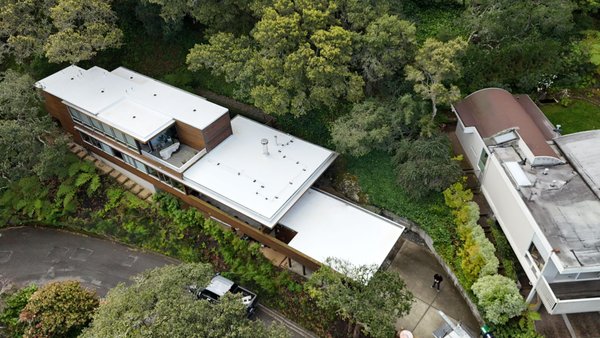 New flat roofing system installed by ELM Roofing Contractors in Sausalito, CA. Watertight and long-lasting. - This flat roof in Sausalito, CA was past its prime. Covered in organic buildup, moss, and long-term wear, it wasn’t just unsightly — it was vulnerable. At ELM Roofing Contractors, we believe every roof should be built to protect — and this one was ready for a full roof replacement.
After inspecting the failing roofing system, we knew patchwork wasn’t going to cut it. Our roofers removed all deteriorated material and exposed the decking to assess structural integrity. With the surface cleaned and reinforced, we began a complete flat roof replacement.
We installed a fully adhered flat roofing membrane — designed for long-term durability, energy efficiency, and leak protection. This included new flashing, edge metal, and a seamless surface that reflects heat and resists pooling.
Flat roofing requires precision, and that’s what we delivered. The clean white finish isn't just aesthetic — it helps manage interior temperatures and extends the life of the roof.
We treat every roof replacement as a long-term investment in the home — built with care, built to last, and built the right way. Call us for any roofing service. New flat roofing system installed by ELM Roofing Contractors in Sausalito, CA. Watertight and long-lasting. - This flat roof in Sausalito, CA was past its prime. Covered in organic buildup, moss, and long-term wear, it wasn’t just unsightly — it was vulnerable. At ELM Roofing Contractors, we believe every roof should be built to protect — and this one was ready for a full roof replacement.
After inspecting the failing roofing system, we knew patchwork wasn’t going to cut it. Our roofers removed all deteriorated material and exposed the decking to assess structural integrity. With the surface cleaned and reinforced, we began a complete flat roof replacement.
We installed a fully adhered flat roofing membrane — designed for long-term durability, energy efficiency, and leak protection. This included new flashing, edge metal, and a seamless surface that reflects heat and resists pooling.
Flat roofing requires precision, and that’s what we delivered. The clean white finish isn't just aesthetic — it helps manage interior temperatures and extends the life of the roof.
We treat every roof replacement as a long-term investment in the home — built with care, built to last, and built the right way. Call us for any roofing service.