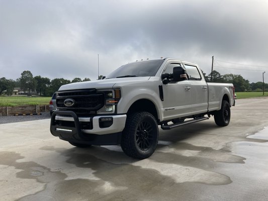 Customization - 2" leveling kit and custom front and rear bumpers with lights installed on a 2022 Ford F350 Super Duty.