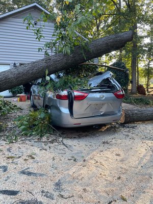 Storm debris removal - Our team safely and efficiently removed the very large oak tree off this customers vehicle. Storm debris removal - Our team safely and efficiently removed the very large oak tree off this customers vehicle.