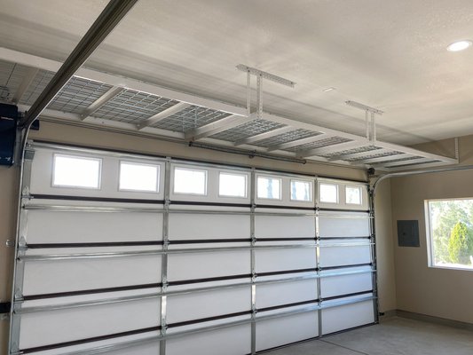 Above Garage Storage - Our Racks can be installed above your garage doors where cabinets and standing racks simply can't go. These can also be connected together to form mega platforms or attached in a corner to create a continuous unit. Give us a call and get your garage organized today!
