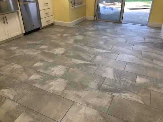 Kitchen floor replacement - 12 x 24 tiles were used to replace old laminate flooring Kitchen floor replacement - 12 x 24 tiles were used to replace old laminate flooring