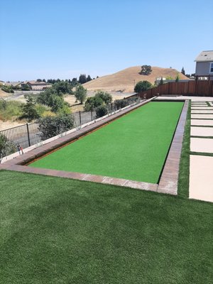 Back yard new construction - This back yard was a new build. Customer wanted entertainment areas and low maintenance. We installed a putting green with lights, Low maintenance planting, veggie garden area, water feature, pavers and drip irrigation.
