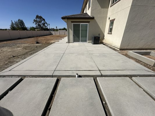 Backyard Concrete Project in Riverside, CA - The homeowner approached us with her own design and a clear vision for her backyard. We worked closely with her to bring that vision to life. The final touch will be installing decorative gravel in the open spaces to complete the look. Beautiful sand finish