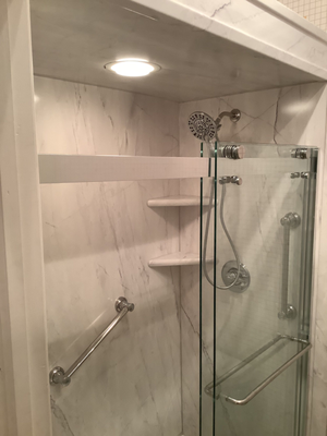 South Sioux City, IA Shower/Tub Combo Transformation designed by Five Star Bath Solutions of Sioux Falls - Five Star Bath Solutions of Sioux Falls recently completed a tub-to-shower conversion in South Sioux City, Nebraska, upgrading an old tub/shower into a safer, more stylish walk-in shower. The new setup includes functional corner storage shelving, sturdy grab bars, a custom shower bench, and a sleek clear glass sliding barn door. The Azzura Bay color adds a refreshing, modern touch to the space. This remodel enhances both safety and style, and our customer is thrilled with the improved accessibility and updated look of their bathroom.