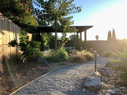 SD Project - A thoughtfully designed garden, comfortable cushioned seating, and vibrant landscaping, offering a calm and inviting outdoor retreat.