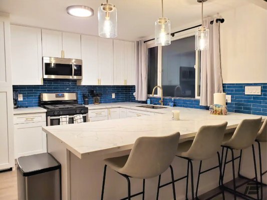 Kitchen Remodel with Blue Tile - Bold blue tile, elegant gold accents, and a kitchen designed to impress. From everyday meals to unforgettable gatherings, this space is now the heart of the home.