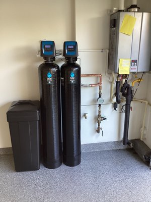 Water Softener and Whole Home Chloramine filtration - This is an installation for a customer with high hardness and Chloramine. Removing hardness is best done by a traditional ion exchange softener. This is the only way to remove 100% of calcium/magnesium. We do not advise the use of "salt-free conditioner" systems as they cannot prove effectiveness nor do they remove any of the high amounts of calcium in the water.
Also installed is a whole home catalytic carbon filtration system designed to remove chloramines and other chemicals associated with the dis-infection process. Water Softener and Whole Home Chloramine filtration - This is an installation for a customer with high hardness and Chloramine. Removing hardness is best done by a traditional ion exchange softener. This is the only way to remove 100% of calcium/magnesium. We do not advise the use of "salt-free conditioner" systems as they cannot prove effectiveness nor do they remove any of the high amounts of calcium in the water.
Also installed is a whole home catalytic carbon filtration system designed to remove chloramines and other chemicals associated with the dis-infection process.