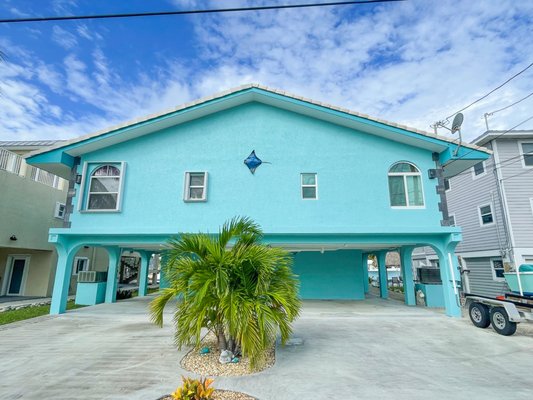Tropical House Exterior - This exterior paint job included the removal of old exterior pop-corn ceiling, (running underneath the house) prep of surfaces by pressure cleaning, and several coats of exterior paint and primer on the ceilings, walls, facia, soffit, and doors. Tropical House Exterior - This exterior paint job included the removal of old exterior pop-corn ceiling, (running underneath the house) prep of surfaces by pressure cleaning, and several coats of exterior paint and primer on the ceilings, walls, facia, soffit, and doors.