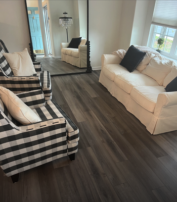 Recently installed Flooring - This customer was look for new flooring that can stand up to traffic and looks great in her home. We helped her pick out this high quality Vinyl Plank Flooring from Mohawk that has both warm and cool tones which works with all the colors in this living room!