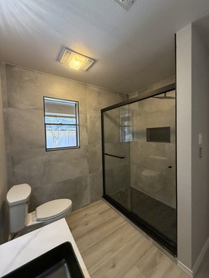 Full Bathroom Remodel – Walk-In Shower | San Antonio - Complete bathroom remodel in San Antonio by Yeromenko LLC. The original bathroom was outdated and inefficient, so we performed a full demolition and installed a modern walk-in shower with large format tile, custom niche, waterproof system, frameless glass enclosure, new vanity, updated lighting, toilet, and luxury vinyl plank flooring. The result is a clean, modern, and durable bathroom built to last. Full Bathroom Remodel – Walk-In Shower | San Antonio - Complete bathroom remodel in San Antonio by Yeromenko LLC. The original bathroom was outdated and inefficient, so we performed a full demolition and installed a modern walk-in shower with large format tile, custom niche, waterproof system, frameless glass enclosure, new vanity, updated lighting, toilet, and luxury vinyl plank flooring. The result is a clean, modern, and durable bathroom built to last.