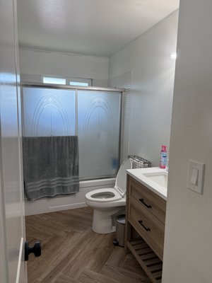 Tadelakt Bathroom Remodel - This bathroom was completely remodeled with a focus on modern design, durability, and everyday functionality. We transformed an outdated space into a clean, spa-inspired bathroom featuring a custom double-sink vanity with warm wood tones and quartz countertops.

The shower was upgraded with a frameless glass enclosure, brushed gold  fixtures, and a custom pebble curbless shower floor for added texture and drainage performance. Large-format wood-look porcelain tile was installed in a herringbone pattern throughout the floor to add warmth while maintaining water resistance and easy maintenance.

Additional upgrades included Venetian plaster wall finishes, recessed LED lighting, updated plumbing fixtures, and a modern floating toilet and  mirror to complete the look. Every detail—from layout to material selection—was carefully executed to deliver a timeless, high-quality bathroom remodel.