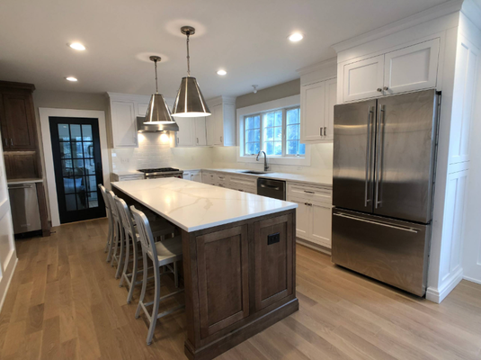 Mountainside Kitchen Remodel: Bright, Beautiful, and Functional! - We took this kitchen from dark wood and dated tile (see the before!) to a stunning, modern masterpiece. The new design features clean white shaker cabinetry paired with a contrasting wood-stained island, instantly brightening the whole space. Key upgrades include a massive island with seating for six, premium quartz countertops, and sleek stainless steel appliances. We created a perfect open-concept kitchen for family gatherings and entertaining in Mountainside, NJ! Mountainside Kitchen Remodel: Bright, Beautiful, and Functional! - We took this kitchen from dark wood and dated tile (see the before!) to a stunning, modern masterpiece. The new design features clean white shaker cabinetry paired with a contrasting wood-stained island, instantly brightening the whole space. Key upgrades include a massive island with seating for six, premium quartz countertops, and sleek stainless steel appliances. We created a perfect open-concept kitchen for family gatherings and entertaining in Mountainside, NJ!